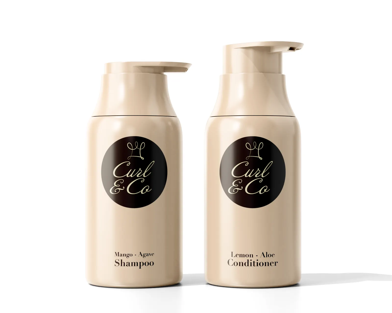 Two cream pump bottles, Mango–Agave Shampoo and Lemon–Aloe Conditioner, each with the Curl & Co. logo in cream on a dark brown circle