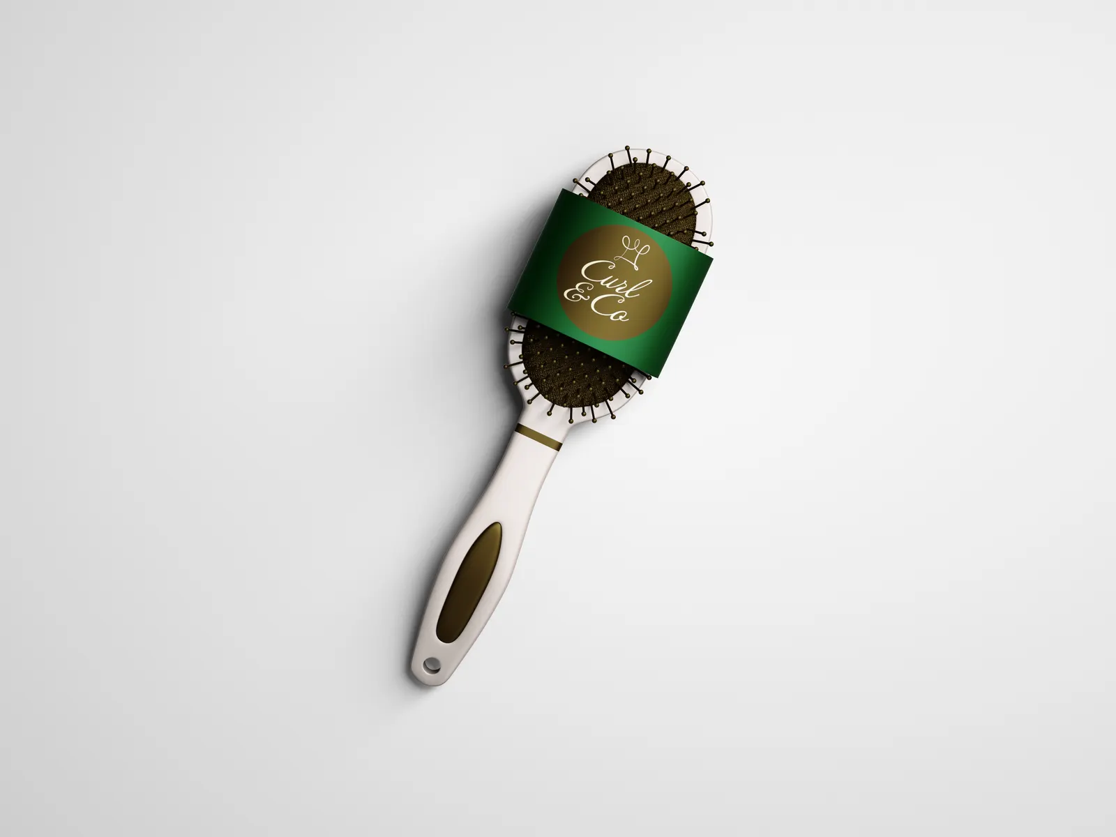 A white hairbrush with a green band carrying the Curl & Co. logo on a gold circle