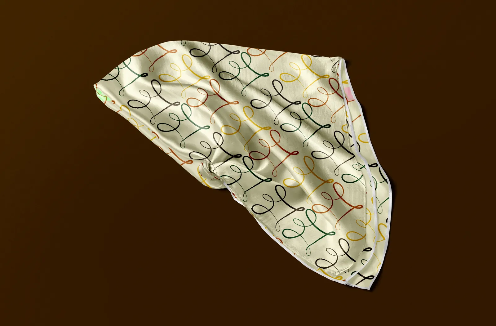 A satin hair scarf printed with the Curl & Co. curl pattern on a dark brown background